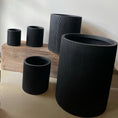 Indlæs billede i gallerivisning, Elegant rund krukke i matsort finish med lodrette striber, Ø45 x H55 cm, ideel til store planter både inde og ude.